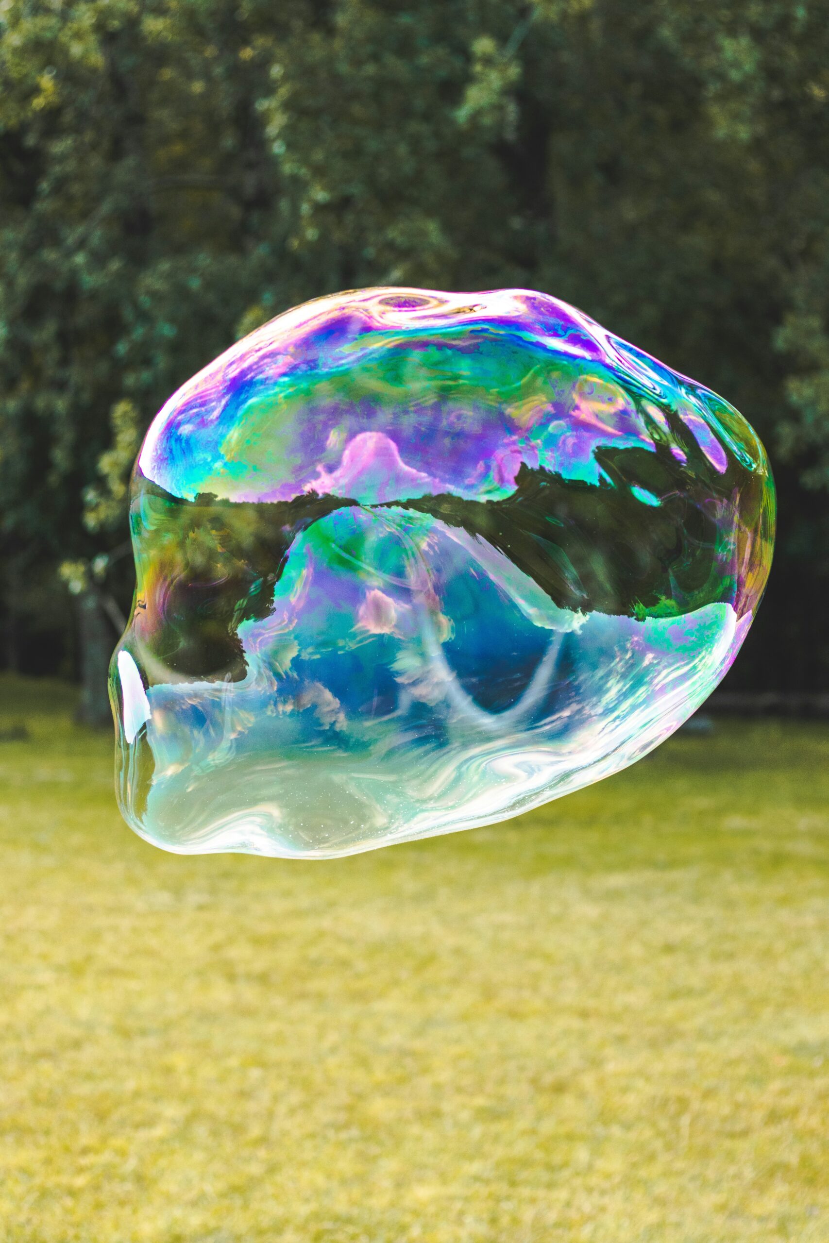 A close-up image of a soap bubble beginning to burst, symbolizing the fragile state of financial or technological markets such as the AI industry.