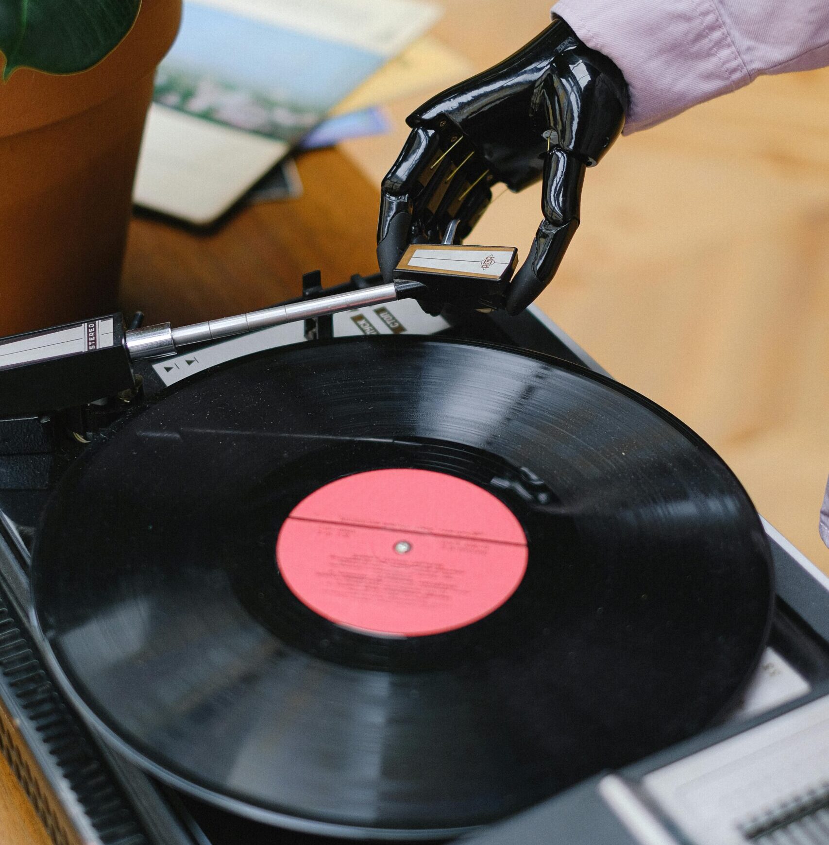 A robotic hand lowering the needle onto a vinyl record player, symbolizing artificial intelligence interacting with traditional music technology and how AI Is reshaping the music industry