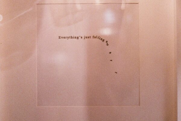 Text artwork with falling letters, symbolic of art and it's meaning