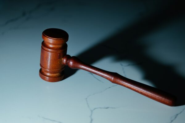A gavel sits backlit ready to sentence those of a financial crime