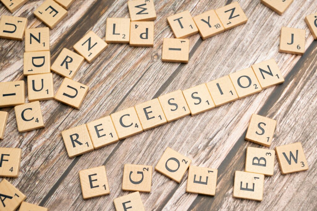 Scrabble tiles spelling 'RECESSION' to talk about the unofficial recession indicators.