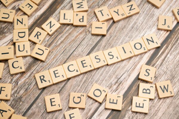 Scrabble tiles spelling 'RECESSION' to talk about the unofficial recession indicators.