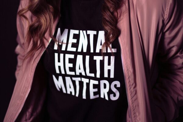 Person wearing shirt promoting mental health but not talking about mental health systems