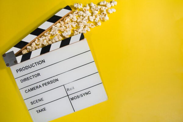 Film clapperboard with popcorn spilling out, a metaphor for The Rise of the Film and TV Budget: The Expanding Cost of Storytelling