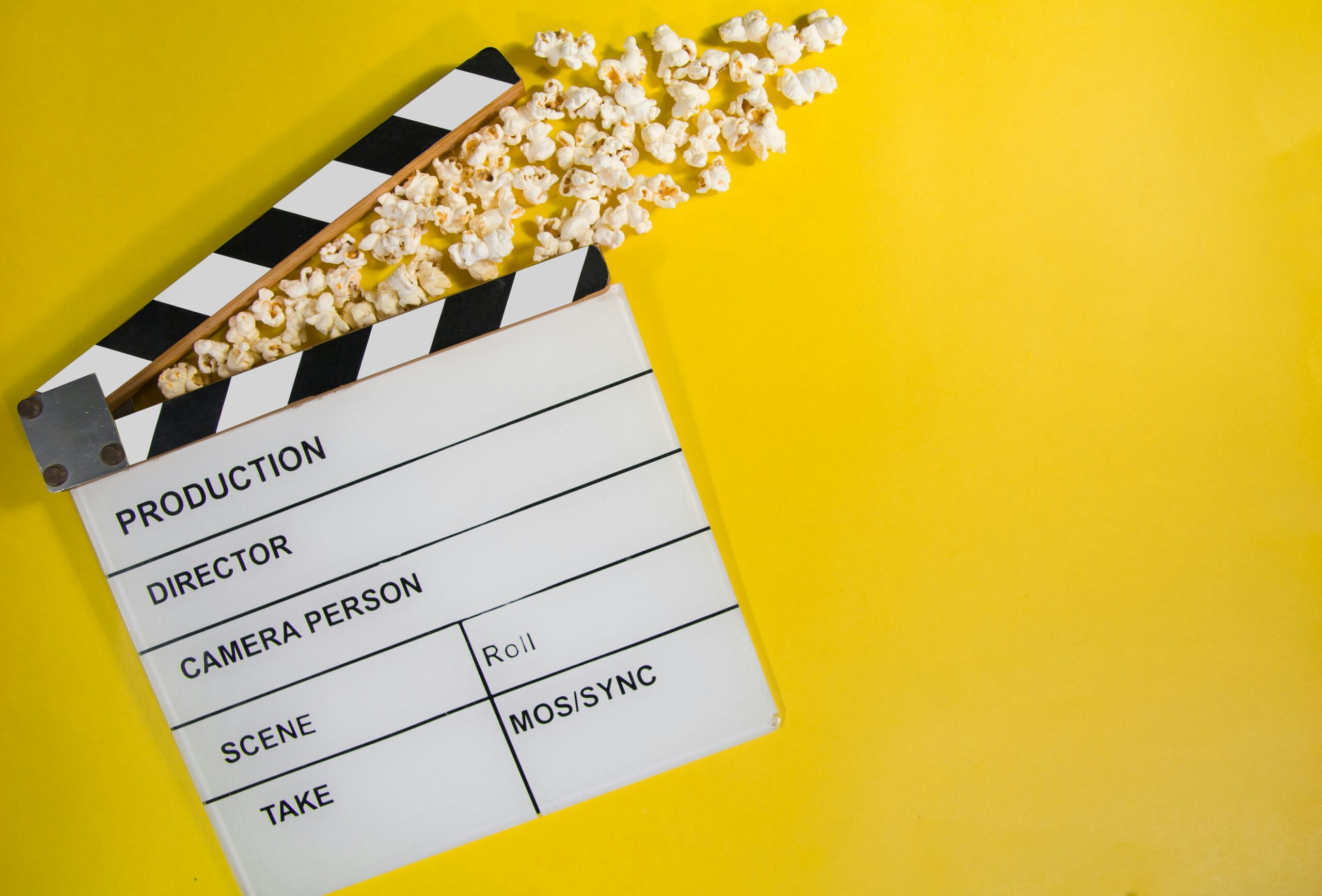 Film clapperboard with popcorn spilling out, a metaphor for The Rise of the Film and TV Budget: The Expanding Cost of Storytelling