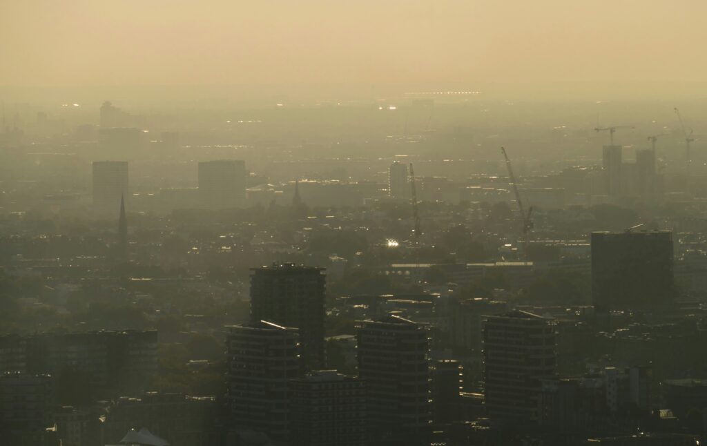 A smog filled city scape, show the poor air quality.