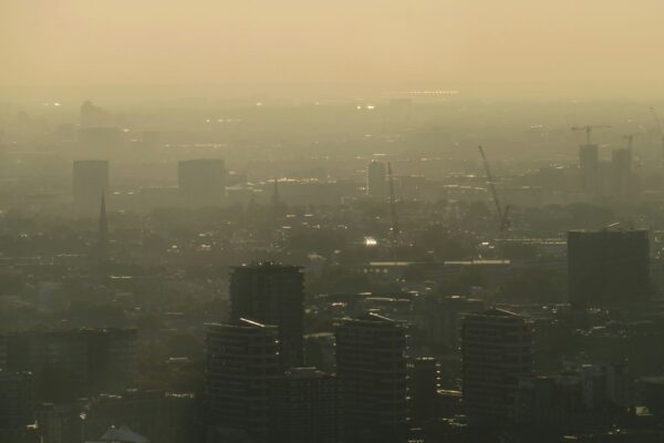 A smog filled city scape, show the poor air quality.