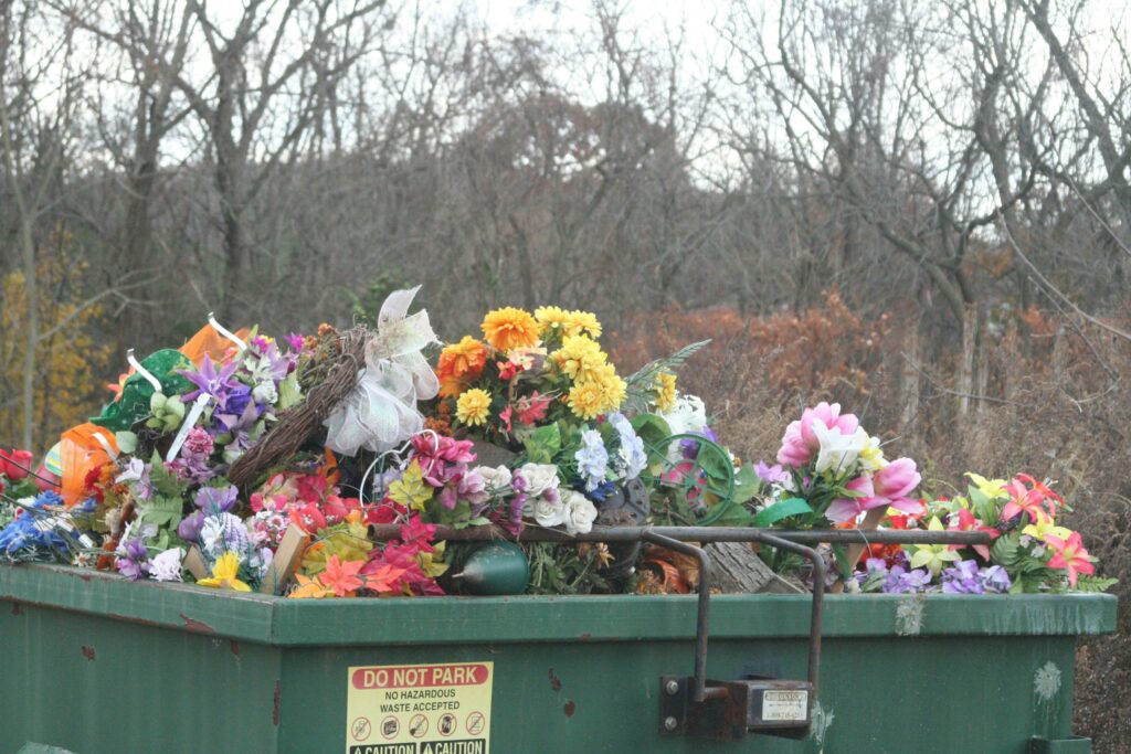 Colorful flowers in a dumpster prime for dumpster diving.