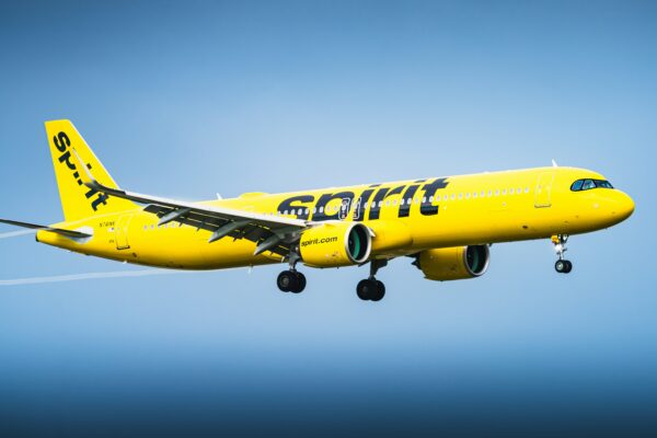 A Picture of a spirit airlines plane flying in the sky