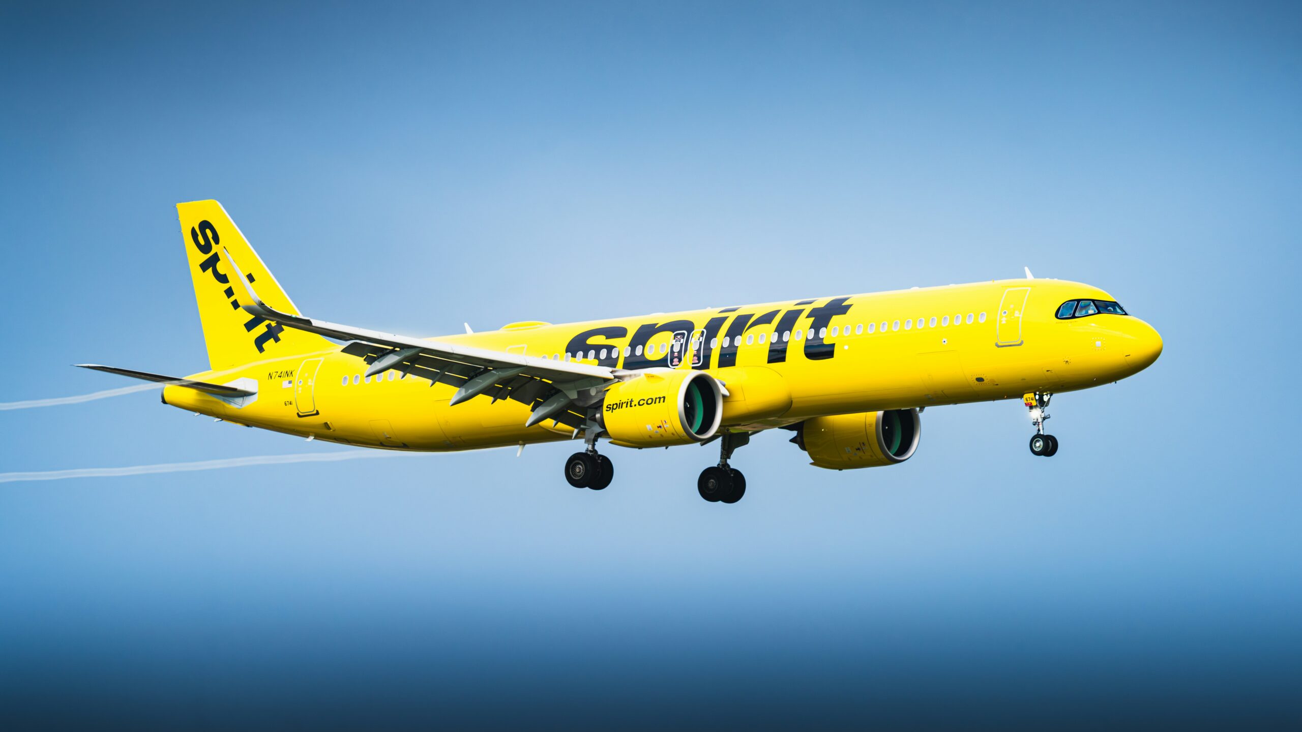 A Picture of a spirit airlines plane flying in the sky