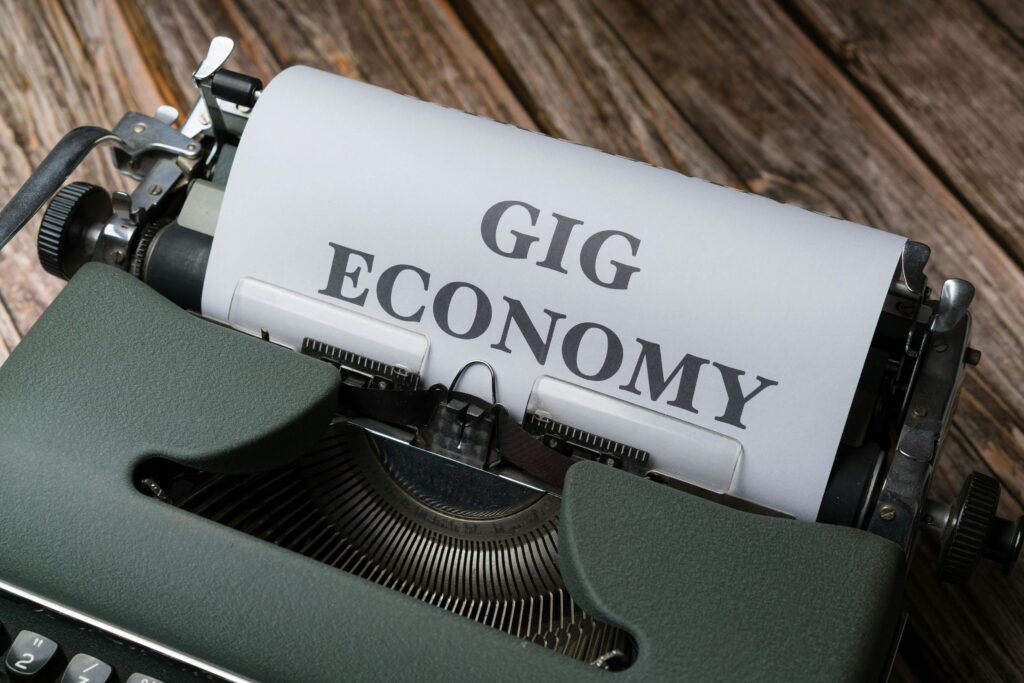 Close-up of a vintage typewriter with 'Gig Economy' typed on paper, showcasing modern work trends.