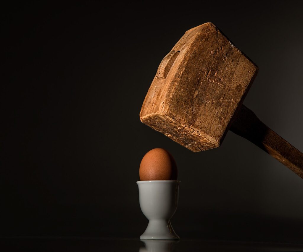 egg, hammer, hit, beat, fragile, vulnerable, threaten, fear, intimidate, force, scare, frighten, coerce, aggression, power, attack, conflict, brutal, coercion, cruel, pounding, anger, smash, blow, shatter, hostile