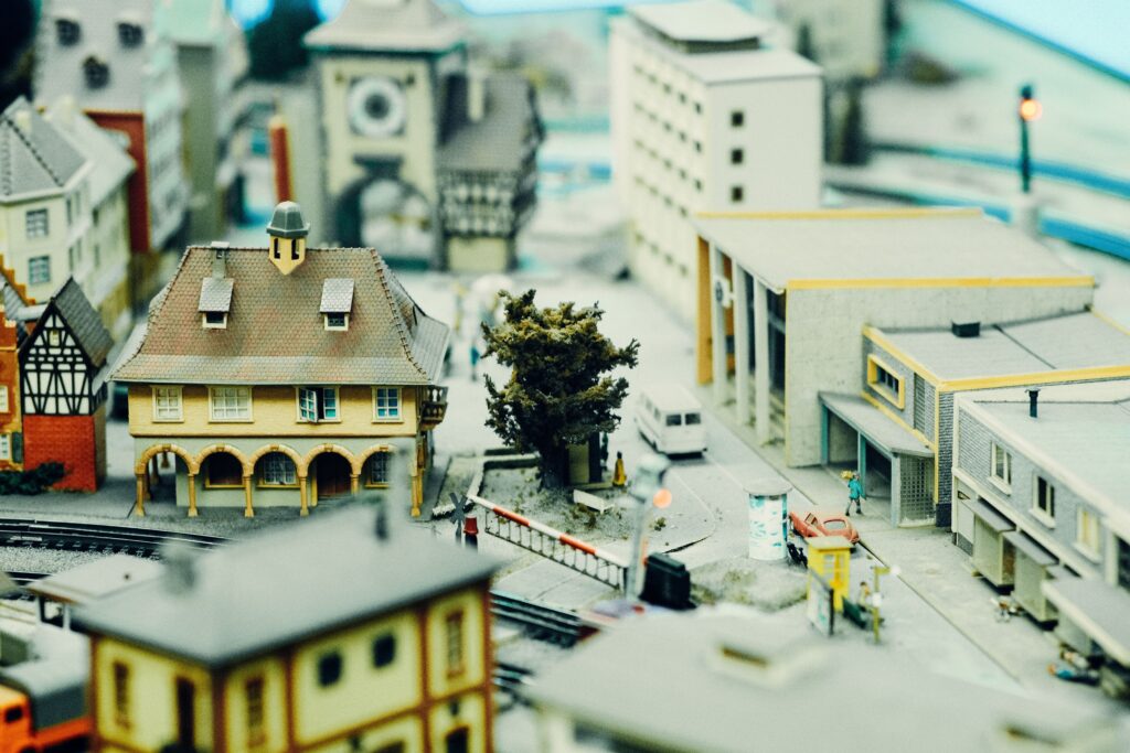Detailed miniature model showing a cityscape with buildings, trees, and roads, capturing urban architecture.
