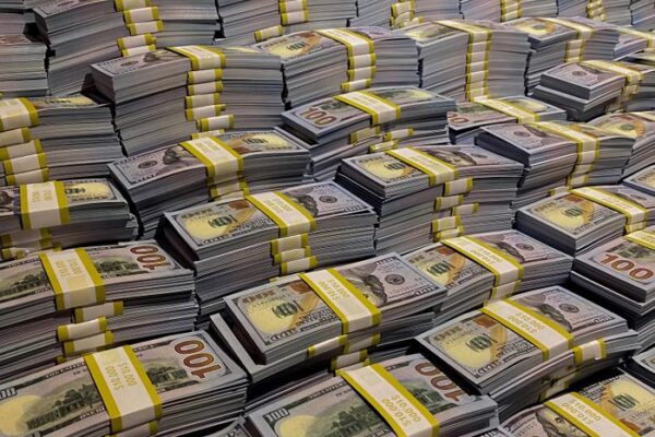 Large piles of 100 US dollar bills neatly stacked, symbolizing wealth and financial abundance.